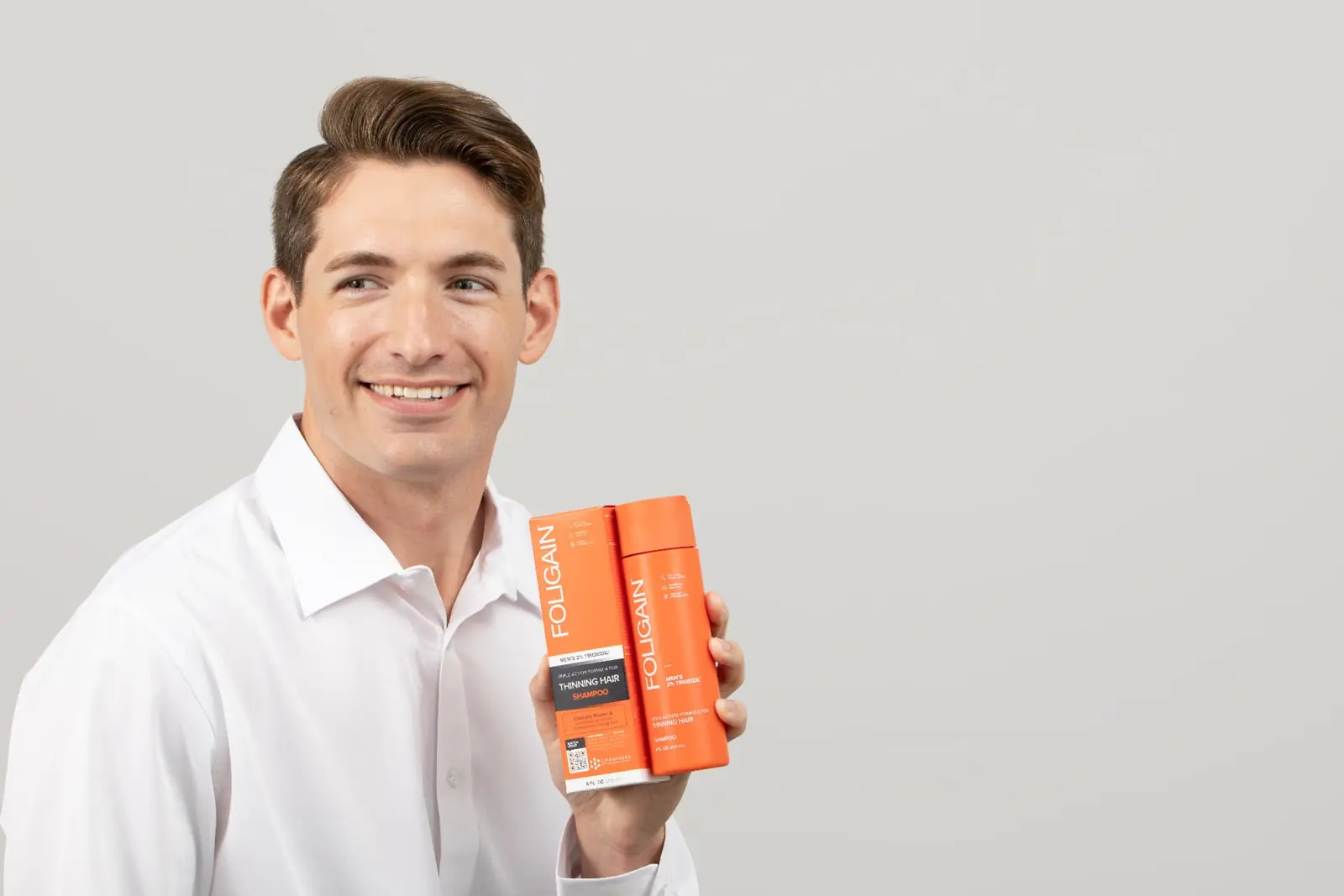 Man smiling with FOLIGAIN® shampoo