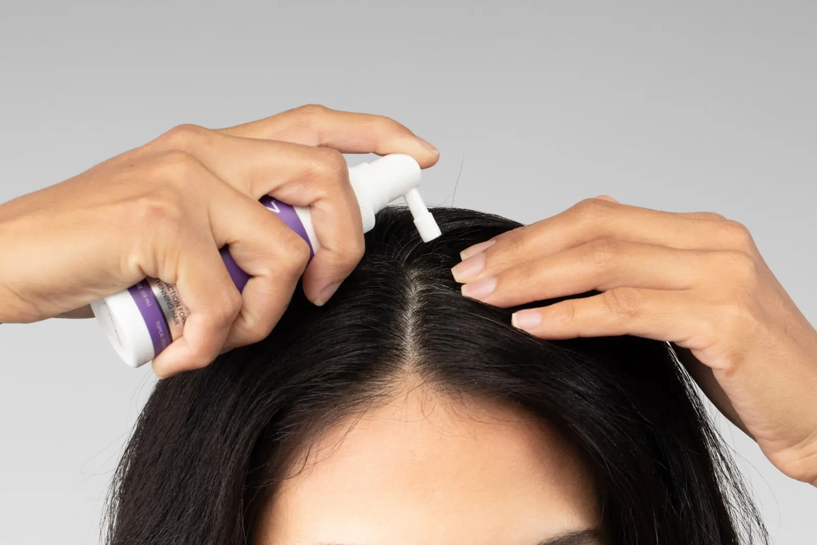 Applying treatment along the hair part