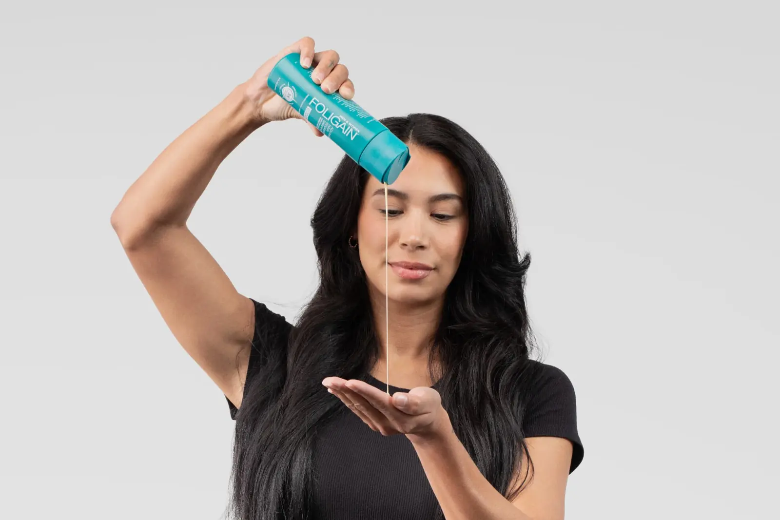 Woman pouring scalp shampoo