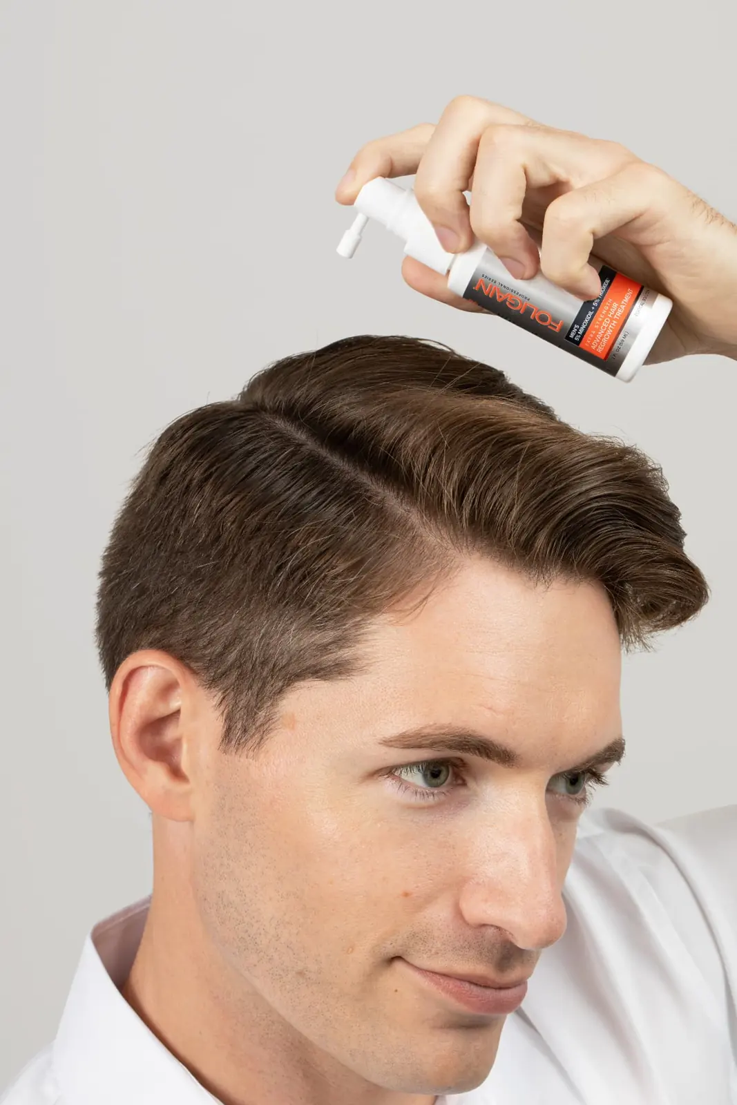 Applying advanced Minoxidil + TRIOXIDIL® spray