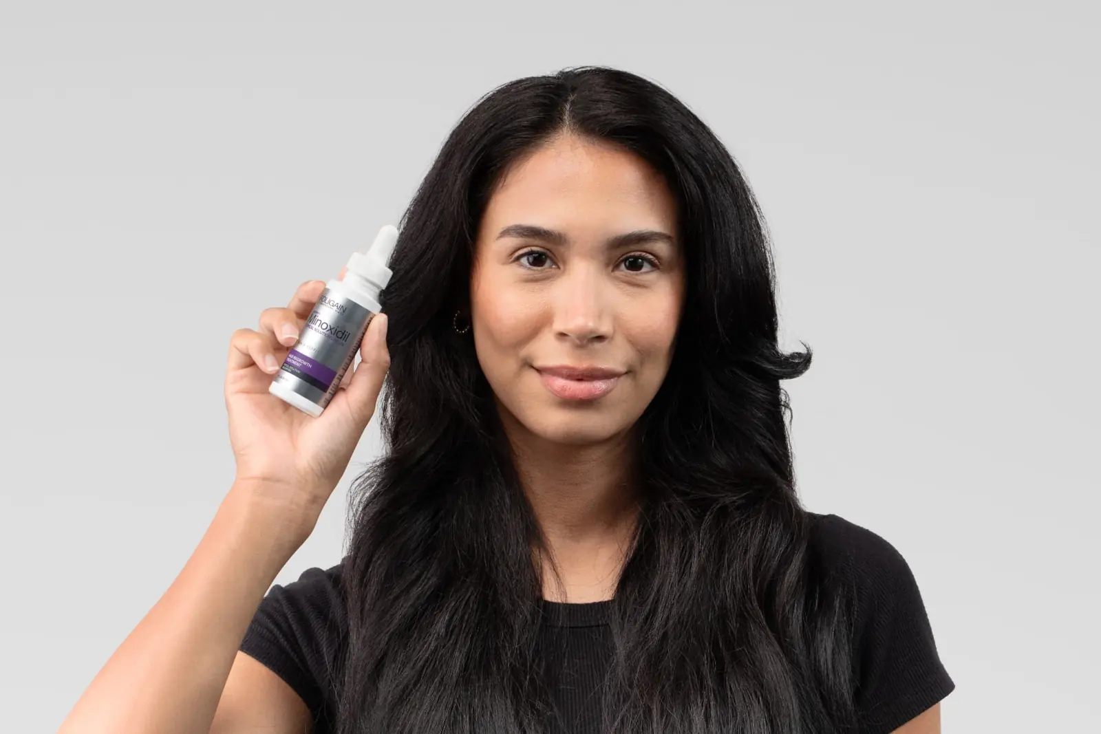 Woman with a women's Minoxidil bottle