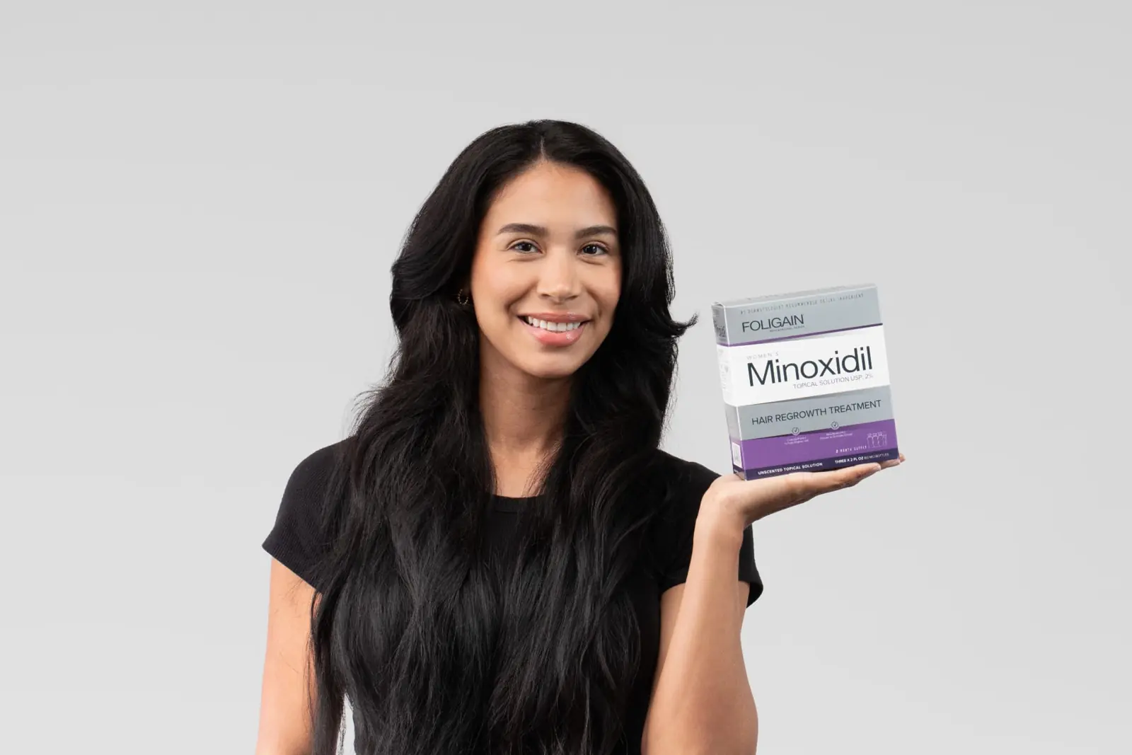 Woman holding women's Minoxidil 2%