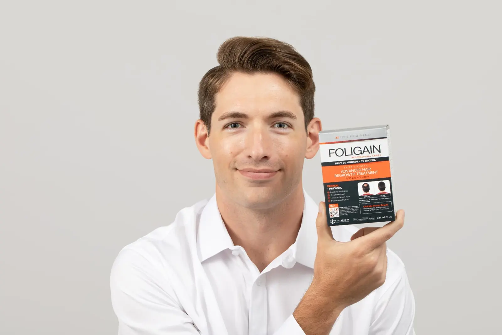 Man holding advanced hair regrowth treatment